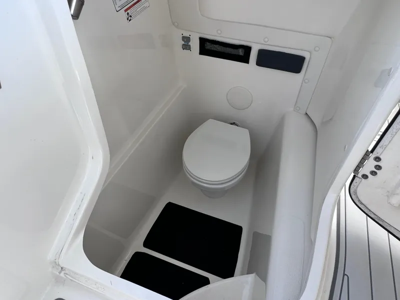 Slide: The Image of 2019 World Cat 255 DC boat interior with seating and dual engines. - 49