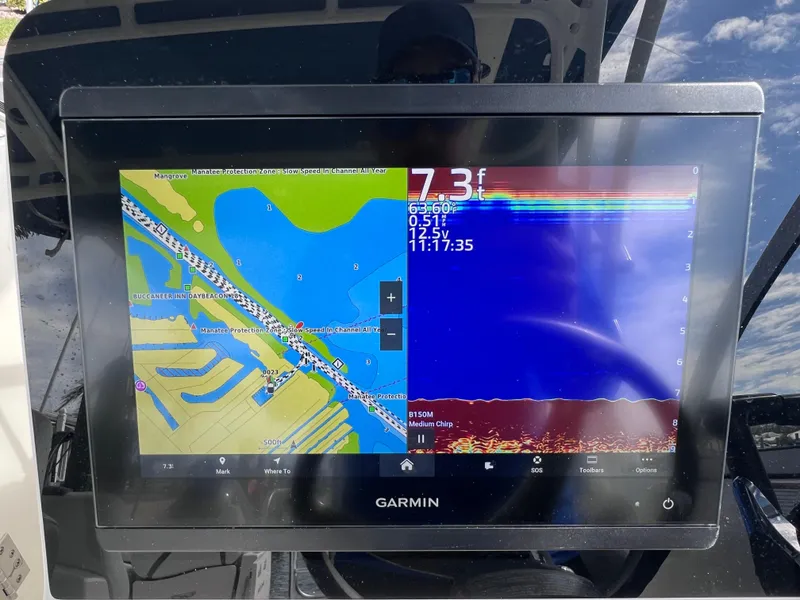 Slide: The Image of 2019 World Cat 255 DC boat interior with seating, docked by the water. - 53