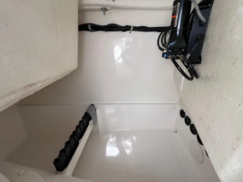 Slide: The Image of 2019 World Cat 255 DC boat seat with storage compartment open by the water. - 56