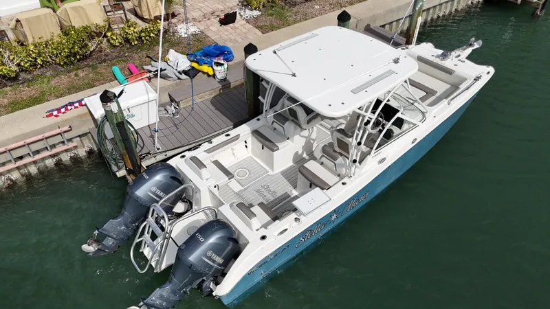 Slide: The Image of 2019 World Cat 255 DC boat on clear blue water under a partly cloudy sky. - 6
