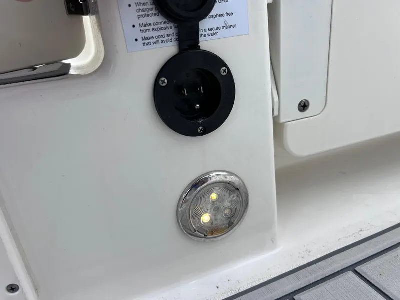 Slide: The Image of 2019 World Cat 255 DC boat dashboard with steering wheel and navigation controls. - 63