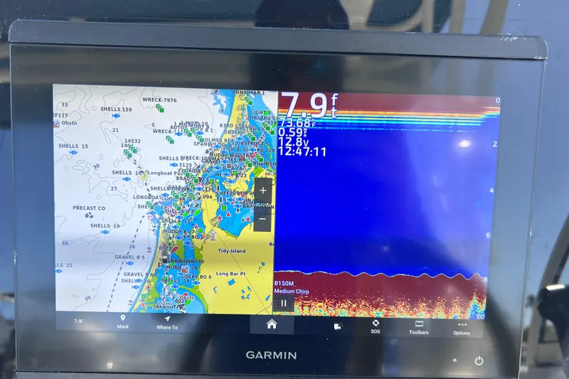 Slide: The Image of Garmin marine GPS display on 2019 World Cat 255 DC, showing navigation map and sonar data. - 70