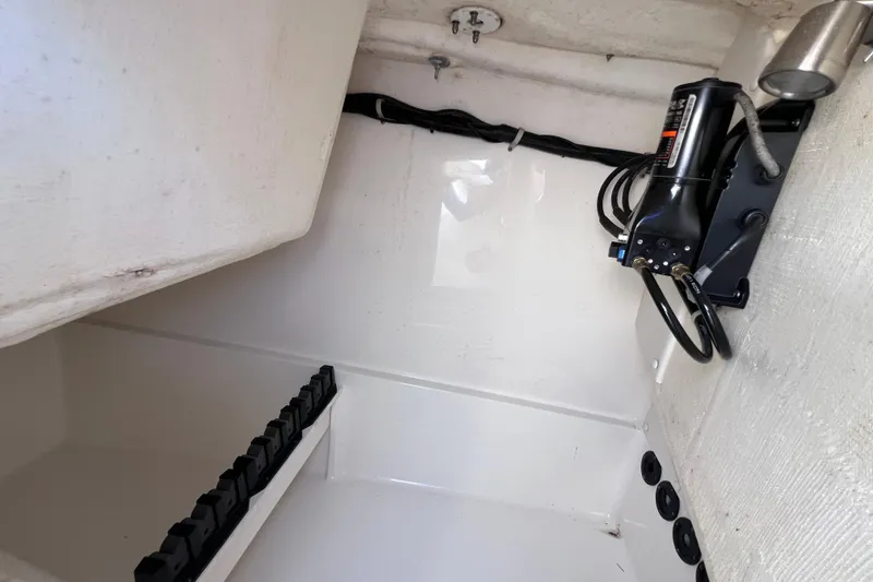 Slide: The Image of Interior view of a 2019 World Cat 255 DC boat compartment with hydraulic equipment. - 77