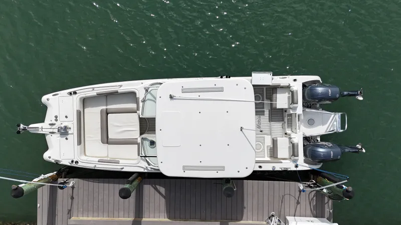 Slide: The Image of 2019 World Cat 255 DC boat on clear turquoise water, featuring dual Yamaha engines. - 8