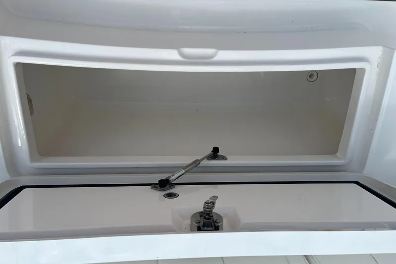 Slide: The Image of 2015 Regulator 25 boat storage compartment with open hatch. - 8