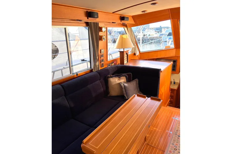 Slide: The Image of 2007 Grand Banks 47 Eastbay FB yacht deck with seating, stairs, and waterfront view. - 11