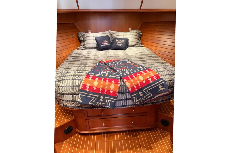 Slide: The Image of 2007 Grand Banks 47 Eastbay FB yacht with tender, featuring spacious wooden deck and chairs. - 14