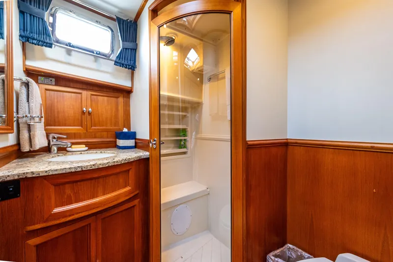 Slide: The Image of Luxurious 2007 Grand Banks 47 Eastbay FB yacht bathroom with wood cabinetry and glass shower. - 37