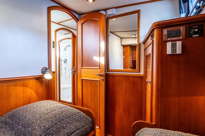 Slide: The Image of Luxurious 2007 Grand Banks 47 Eastbay FB cabin interior with wood paneling and ensuite bathroom. - 38
