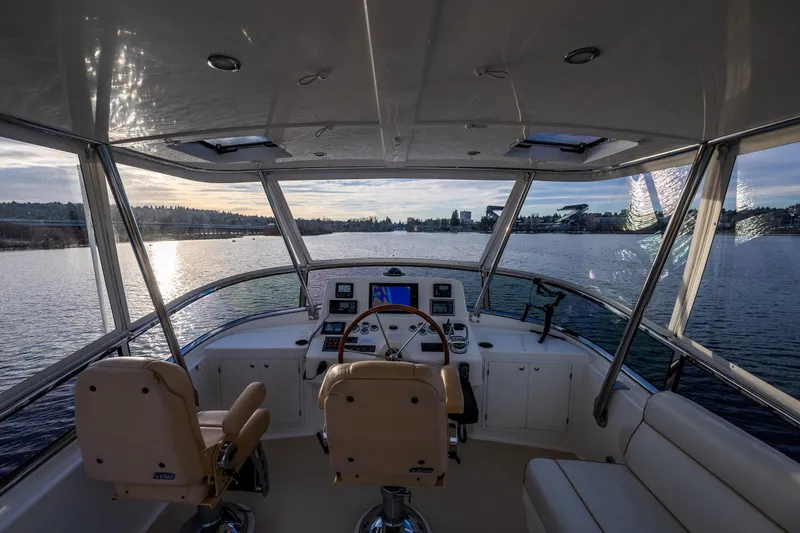 Slide: The Image of Interior view of 2007 Grand Banks 47 Eastbay FB yacht helm, overlooking serene waters. - 54