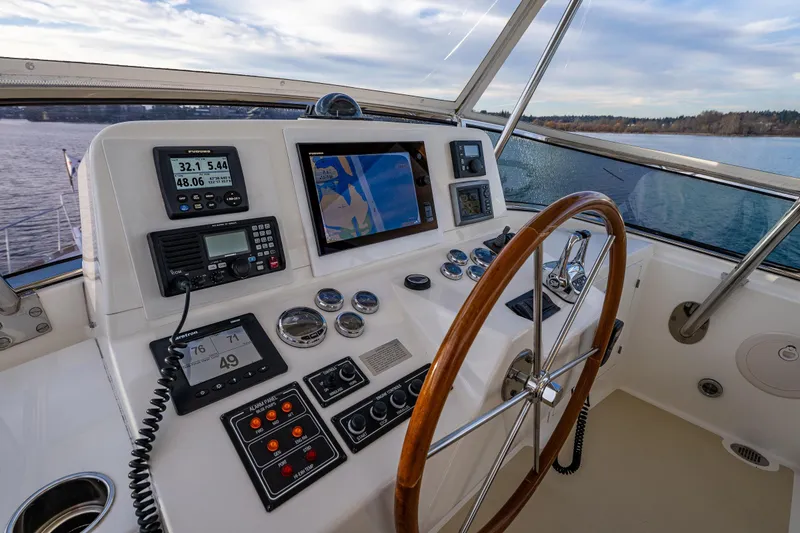 Slide: The Image of Helm of 2007 Grand Banks 47 Eastbay FB with navigation instruments and wooden steering wheel. - 56