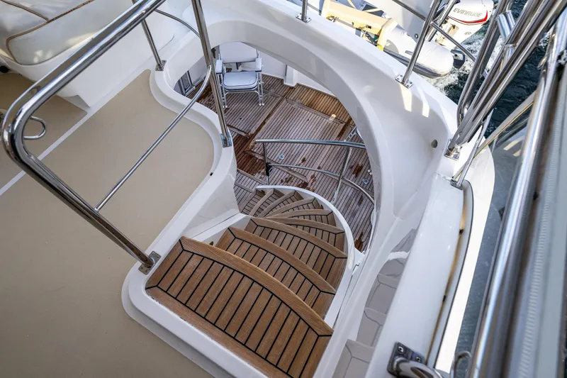 Slide: The Image of Staircase on 2007 Grand Banks 47 Eastbay FB yacht with teak steps and stainless steel railings. - 59