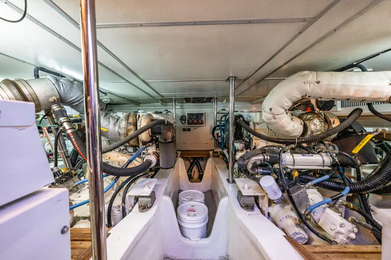 Slide: The Image of Engine room of 2007 Grand Banks 47 Eastbay FB yacht, showcasing complex machinery and piping. - 61