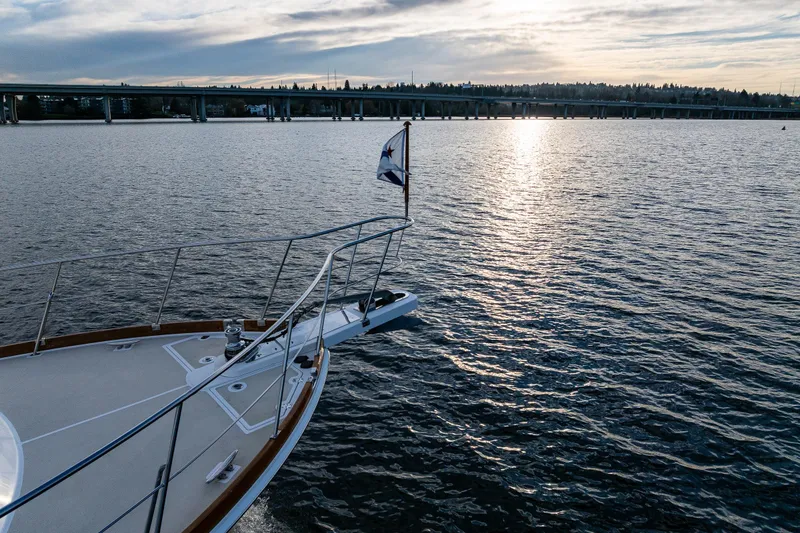 Slide: The Image of Bow of 2007 Grand Banks 47 Eastbay FB yacht on calm water at sunset. - 78