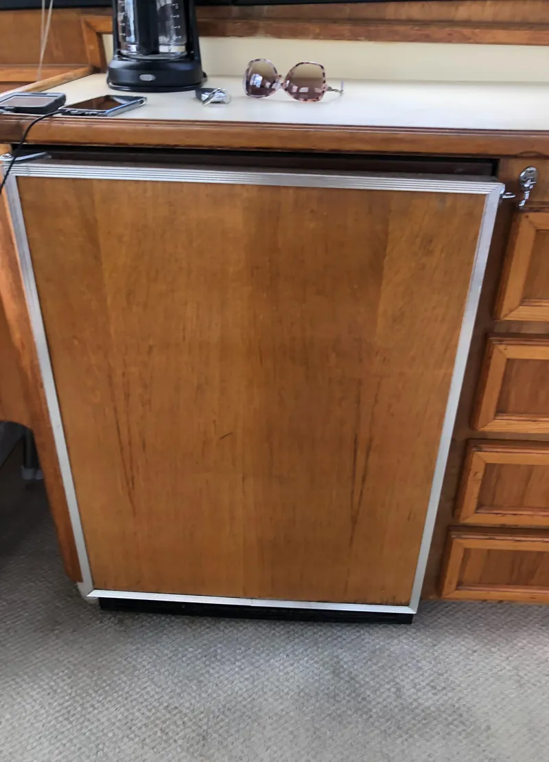 Slide: The Image of Wood-paneled fridge in 1987 Egg Harbor Convertible 37 yacht. - 22