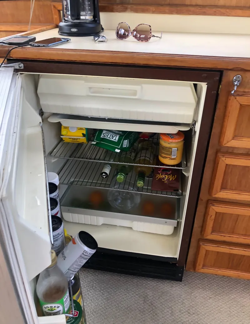 Slide: The Image of Open fridge on 1987 Egg Harbor Convertible 37 boat. - 23