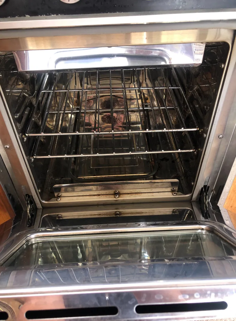 Slide: The Image of Open oven with shiny interior and wire racks. - 27