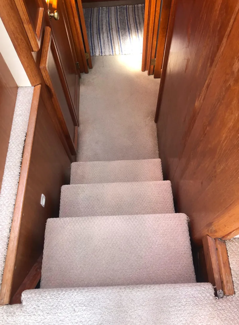 Slide: The Image of Carpeted stairs inside a 1987 Egg Harbor Convertible 37. - 31