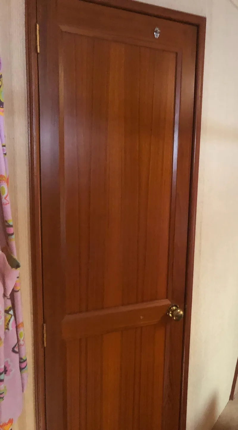 Slide: The Image of Wooden door on 1987 Egg Harbor Convertible 37 boat. - 37