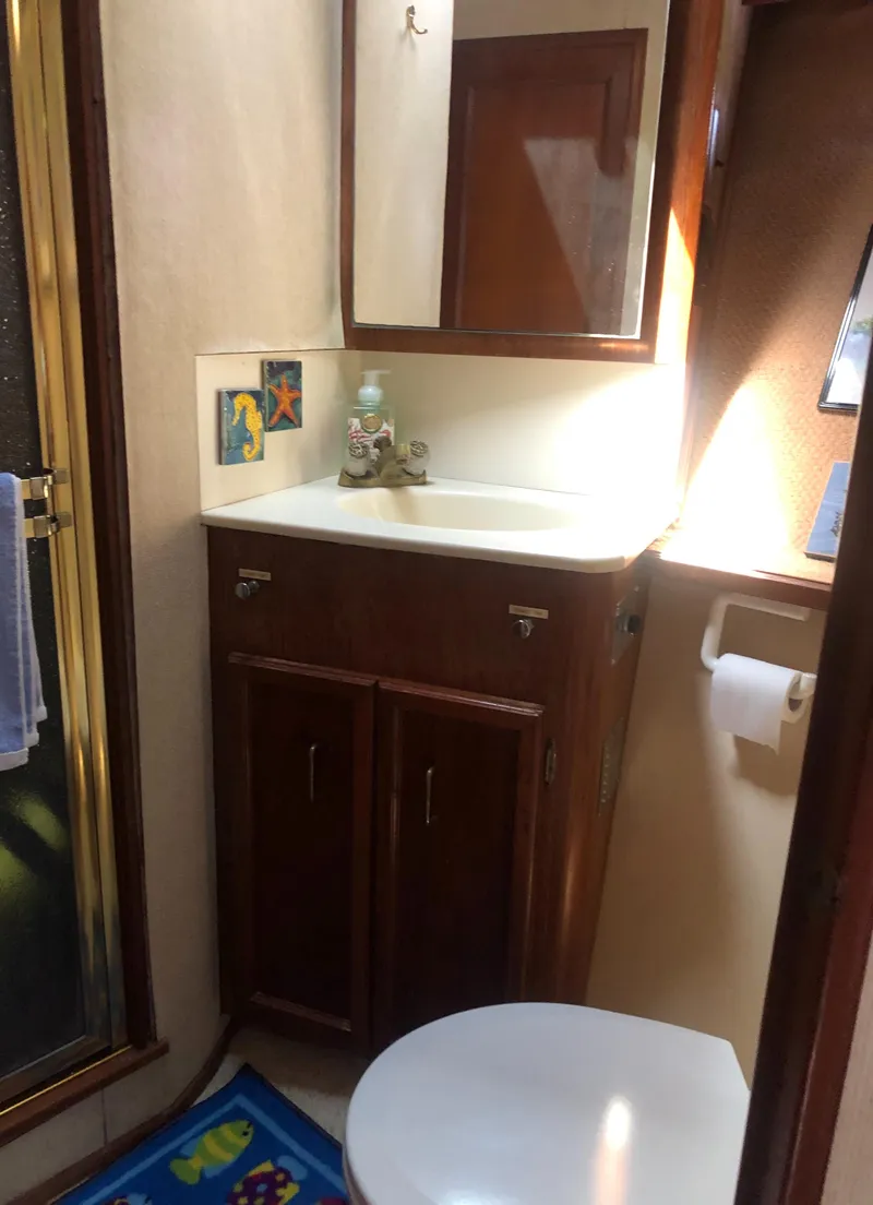 Slide: The Image of Bathroom in 1987 Egg Harbor Convertible 37 with sink and mirror. - 38