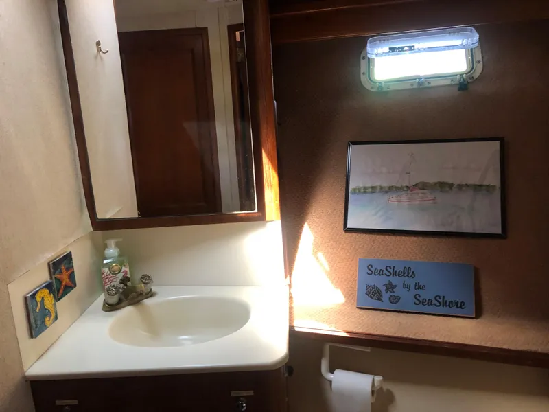 Slide: The Image of Bathroom in 1987 Egg Harbor Convertible 37 boat with sink and decorations. - 40