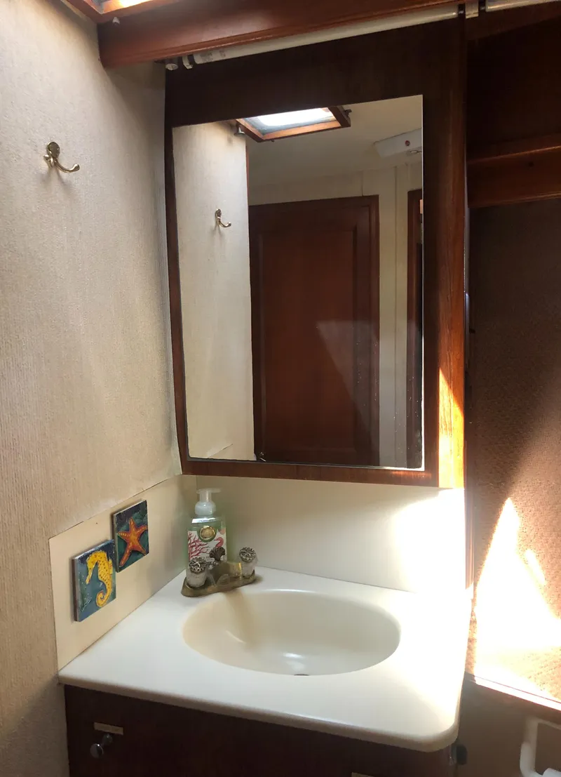 Slide: The Image of Bathroom in 1987 Egg Harbor Convertible 37 with mirror and sink. - 41
