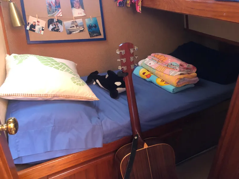 Slide: The Image of Cabin on a 1987 Egg Harbor Convertible 37 boat with bed and guitar. - 46