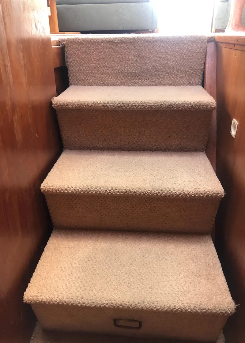 Slide: The Image of Carpeted stairs inside a 1987 Egg Harbor Convertible 37. - 48