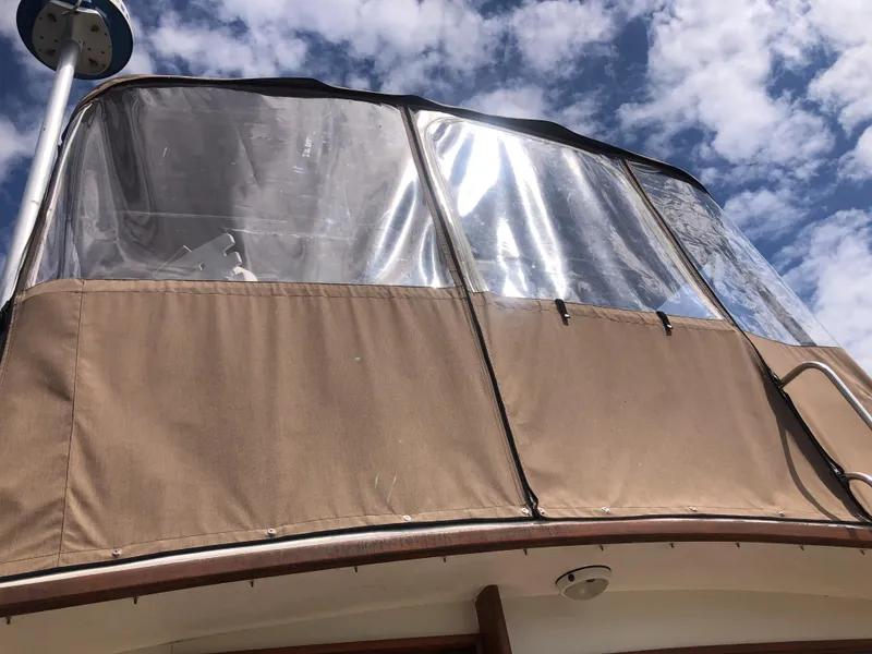 Slide: The Image of Egg Harbor Convertible 37 boat, 1987 model, with canopy under blue sky. - 5