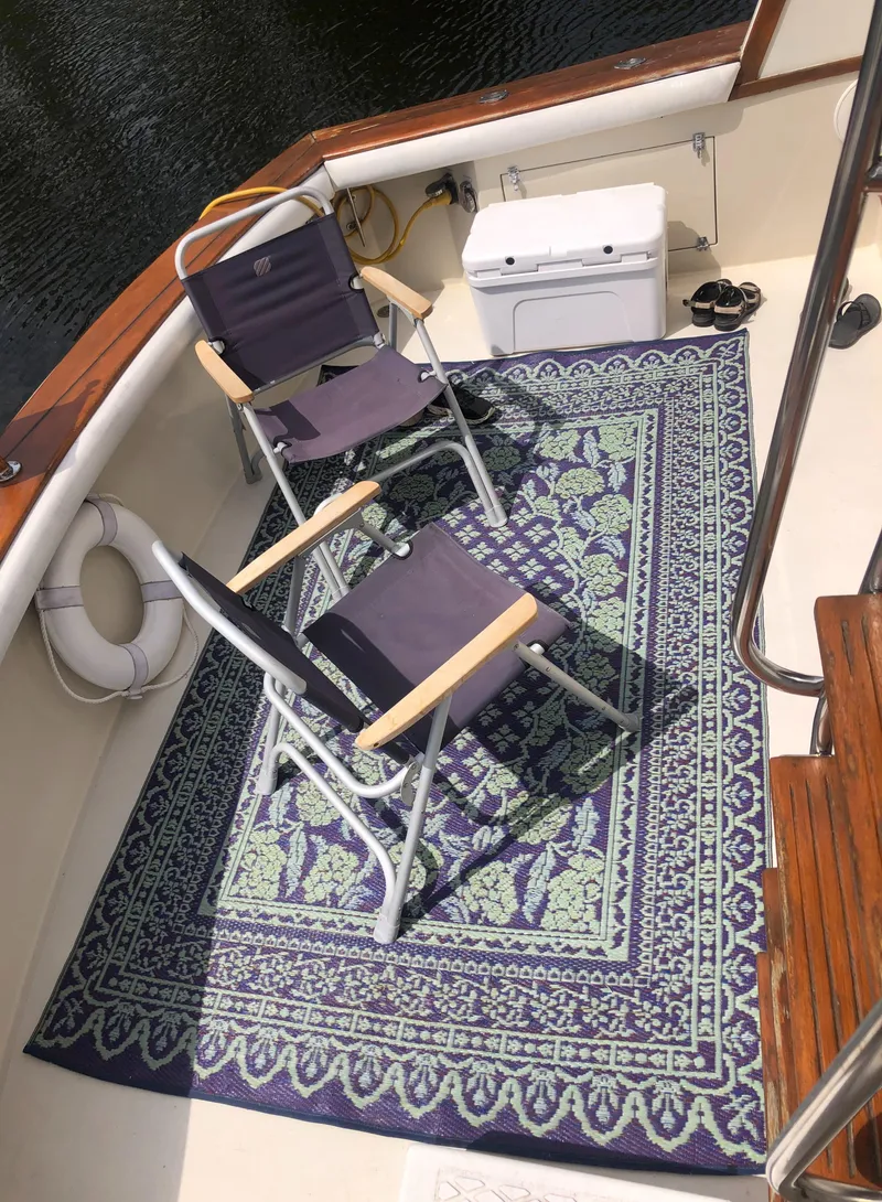 Slide: The Image of 1987 Egg Harbor Convertible 37 deck with chairs and rug. - 7