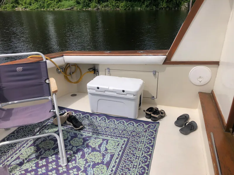 Slide: The Image of 1987 Egg Harbor Convertible 37 deck with chair and cooler. - 9