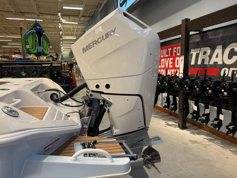 Slide: The Image of 2024 Ranger 2600 Bay boat with Mercury outboard motor in showroom. - 4