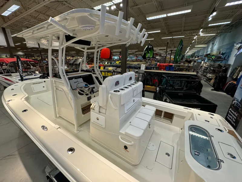Slide: The Image of 2024 Ranger 2600 Bay boat on display in a showroom. - 5