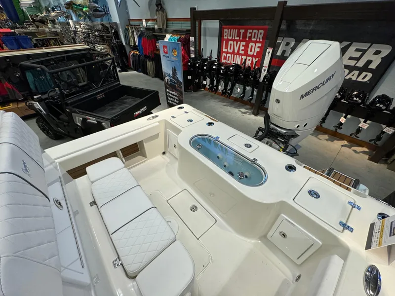 Slide: The Image of 2024 Ranger 2600 Bay boat interior with Mercury outboard motor in showroom. - 6