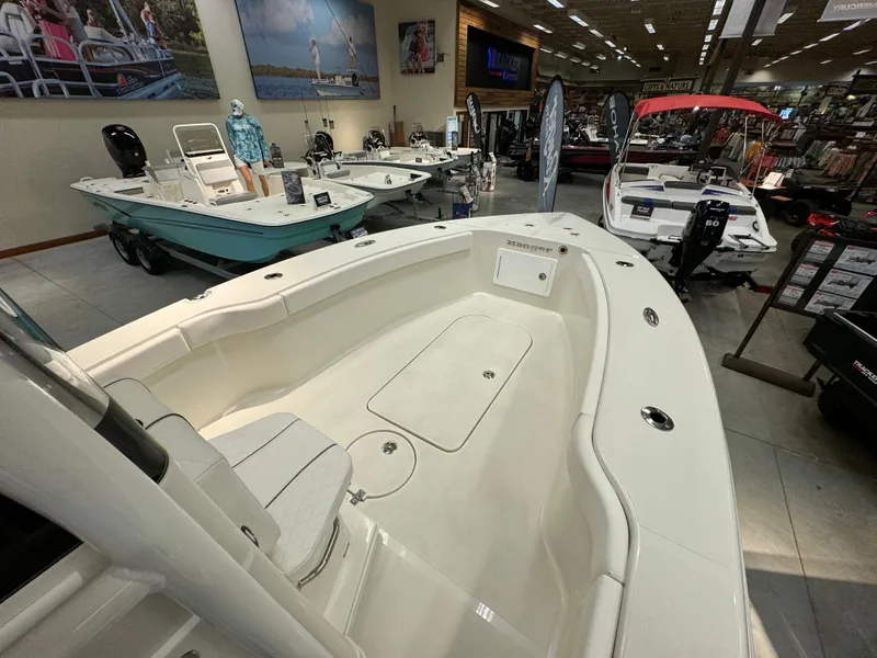 Slide: The Image of 2024 Ranger 2600 Bay boat on display in a showroom. - 8
