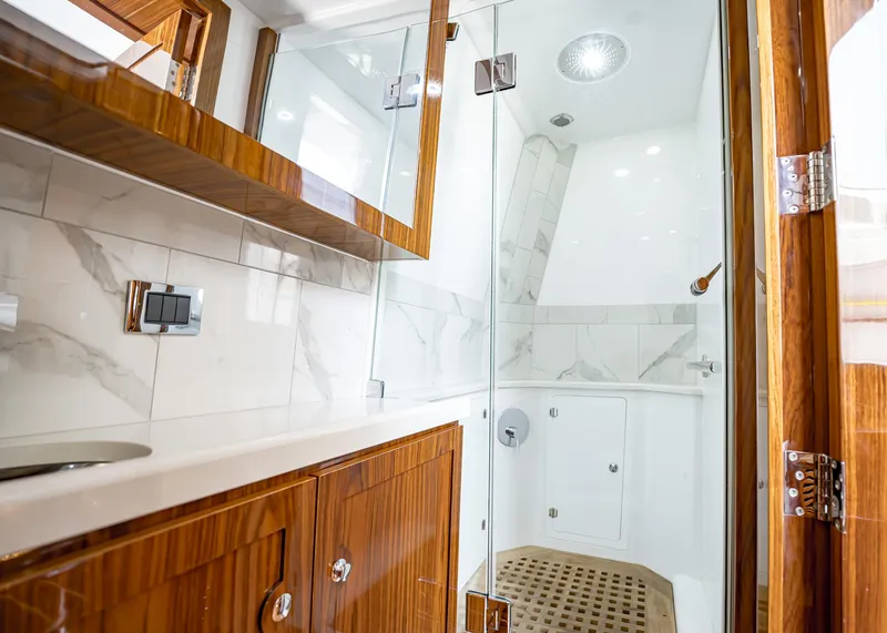 Slide: The Image of Luxurious bathroom in 2021 HCB Estrella yacht with wooden cabinetry and glass shower. - 10