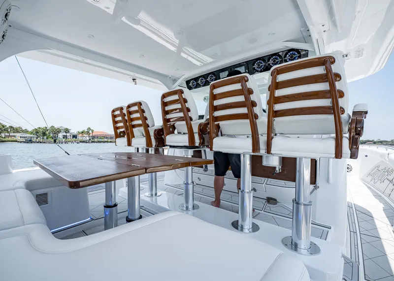 Slide: The Image of Luxury seating area on 2021 HCB Estrella yacht with wooden chairs and table. - 11