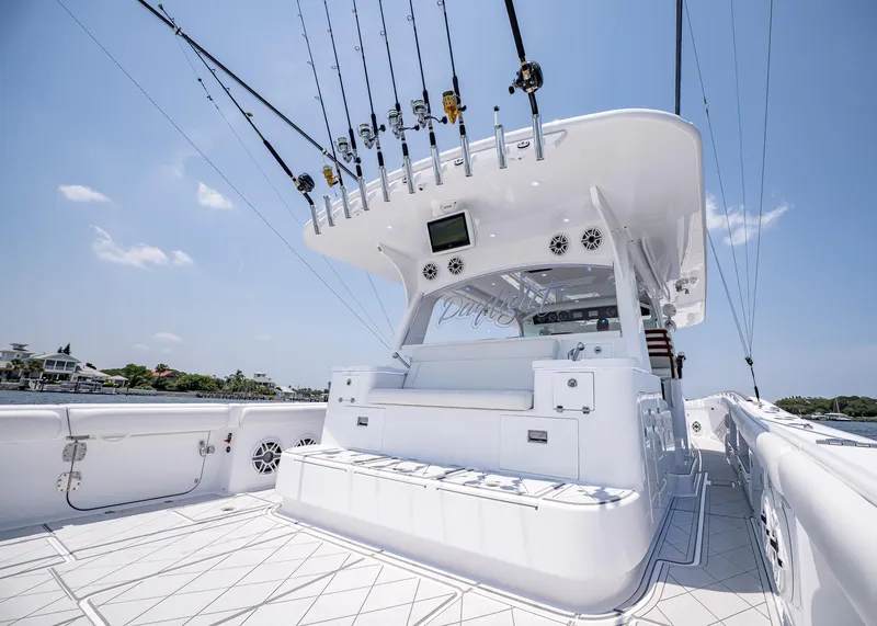 Slide: The Image of 2021 HCB Estrella boat with fishing rods, white deck, and luxurious seating. - 13