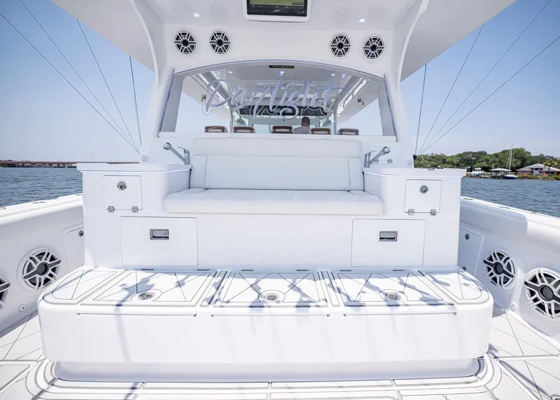 Slide: The Image of 2021 HCB Estrella boat interior with white seating and storage compartments. - 15