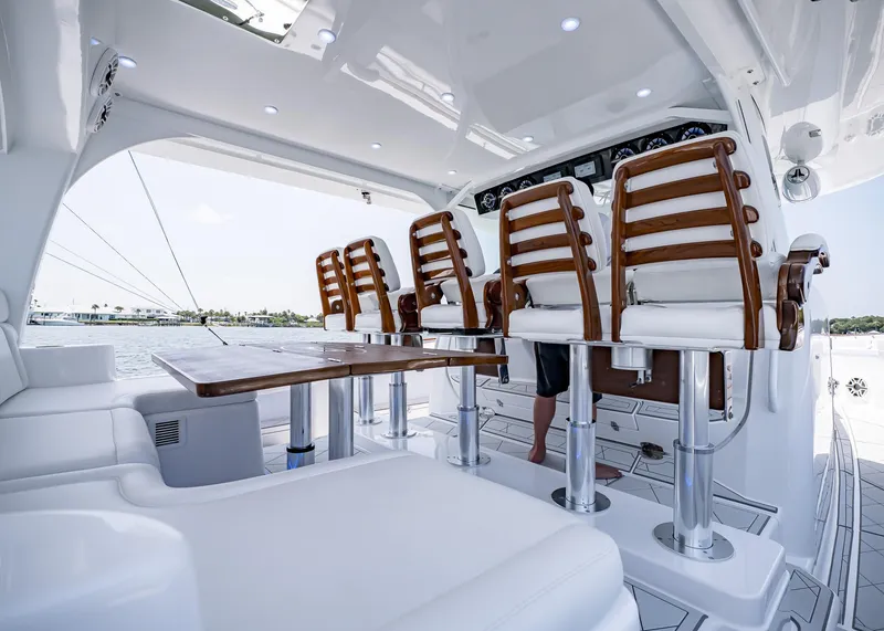 Slide: The Image of Luxury seating area on 2021 HCB Estrella yacht with wooden chairs and white upholstery. - 17