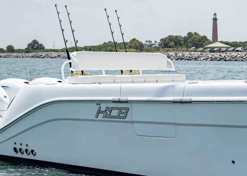 Slide: The Image of 2021 HCB Estrella boat with fishing rods, lighthouse in background. - 19