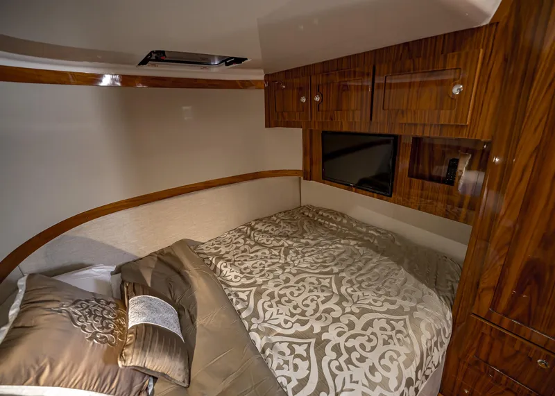 Slide: The Image of Luxurious cabin interior of 2021 HCB Estrella with elegant bedding and wooden cabinetry. - 26