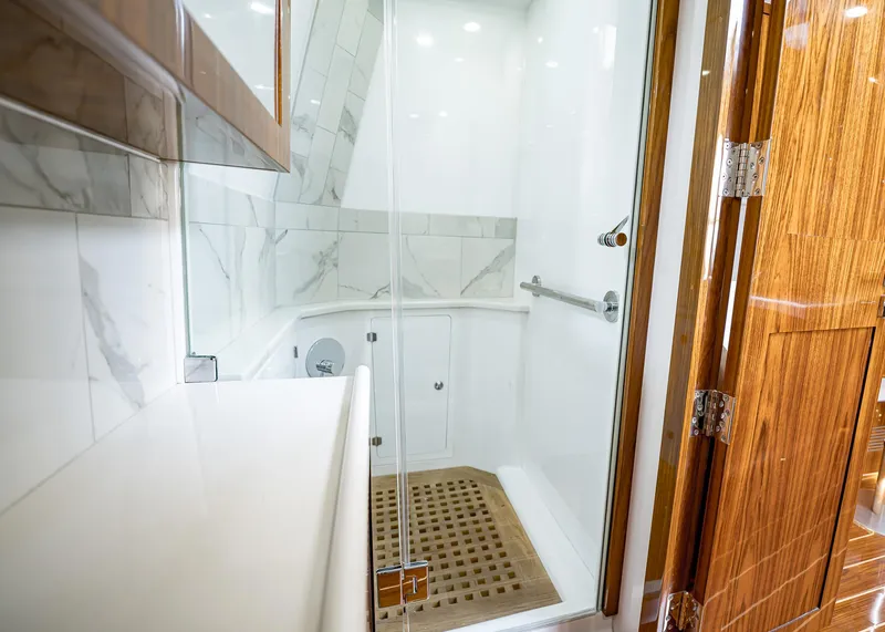 Slide: The Image of Luxurious bathroom in 2021 HCB Estrella yacht with marble tiles and wooden accents. - 28