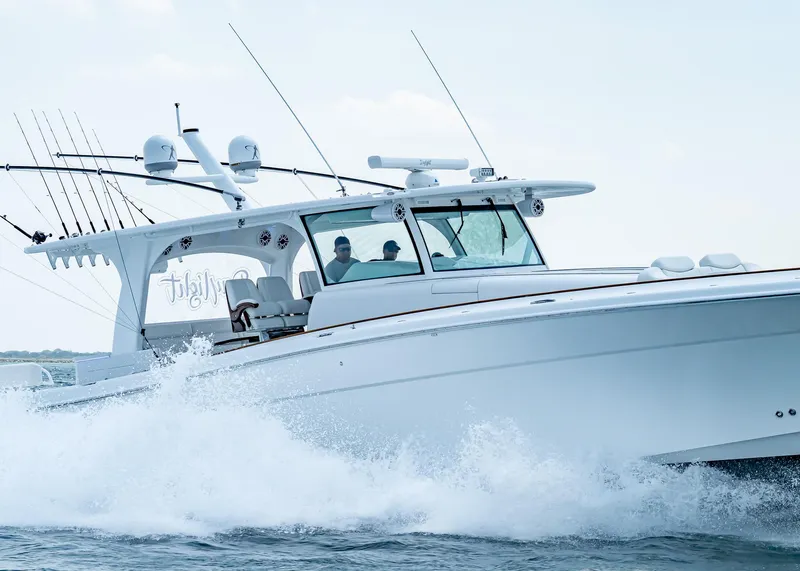 Slide: The Image of 2021 HCB Estrella boat cruising on water with fishing rods and radar equipment. - 3