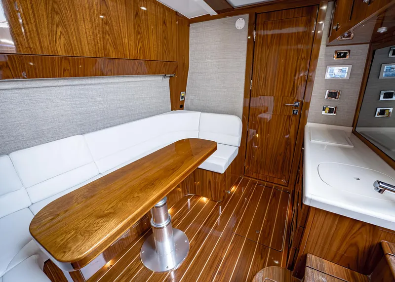 Slide: The Image of Luxurious interior of 2021 HCB Estrella yacht with wooden finishes and white seating. - 30