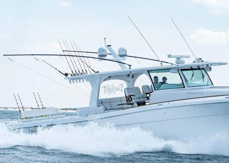 Slide: The Image of 2021 HCB Estrella boat cruising on the water with fishing rods. - 4