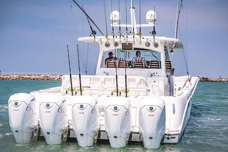 Slide: The Image of HCB Estrella 2021 boat with multiple outboard engines and fishing rods in the water. - 5