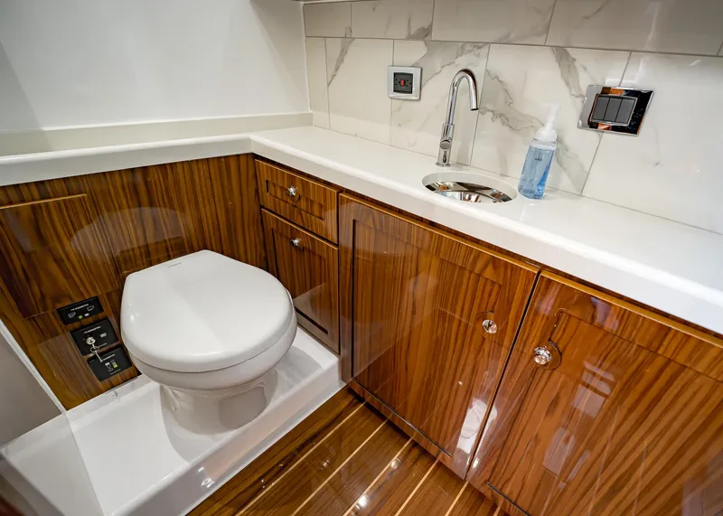 Slide: The Image of Luxurious 2021 HCB Estrella yacht bathroom with wood cabinetry, modern fixtures, and marble accents. - 9