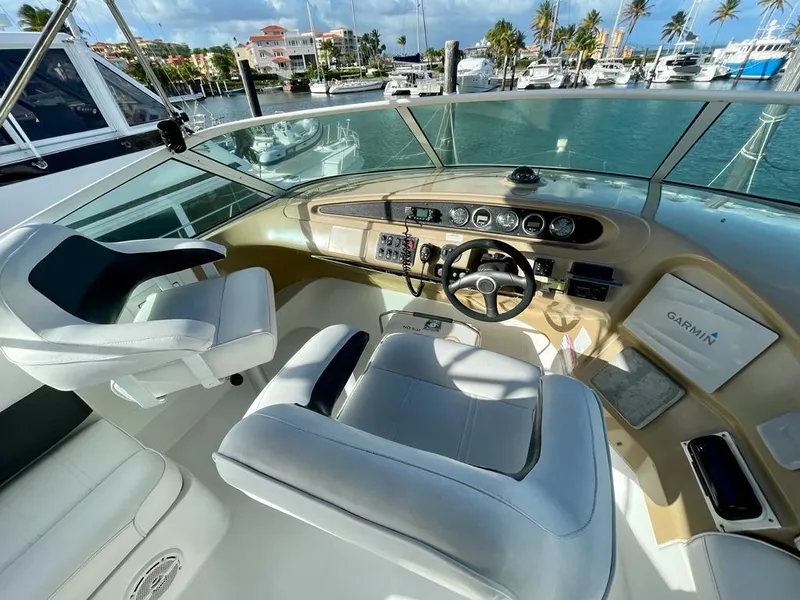 Slide: The Image of Helm of 2000 Carver 45 Voyager yacht with modern controls and marina view. - 2