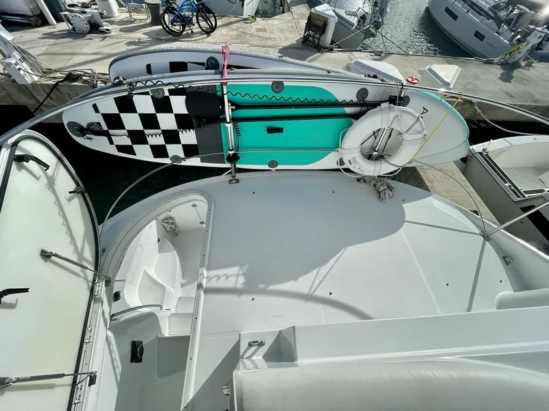 Slide: The Image of 2000 Carver 45 Voyager yacht deck with paddleboard and life preserver. - 3